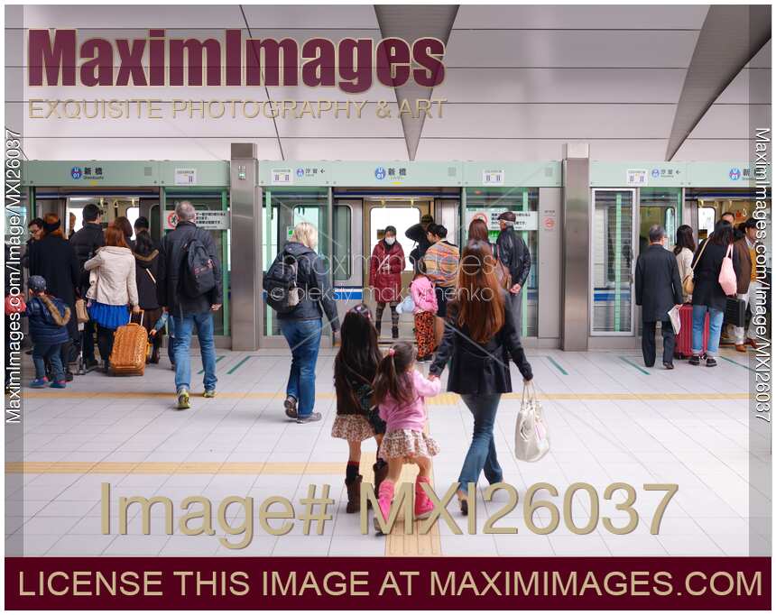 People boarding Yurikamome automated train in Tokyo Japan