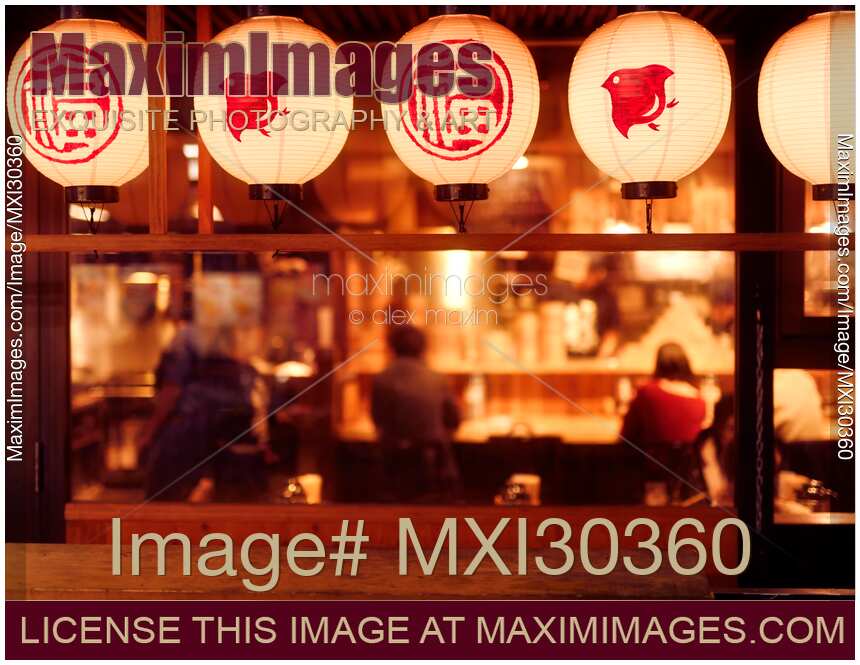 People dining inside a traditional Japanese restaurant with lanters lit up at night Gion Kyoto