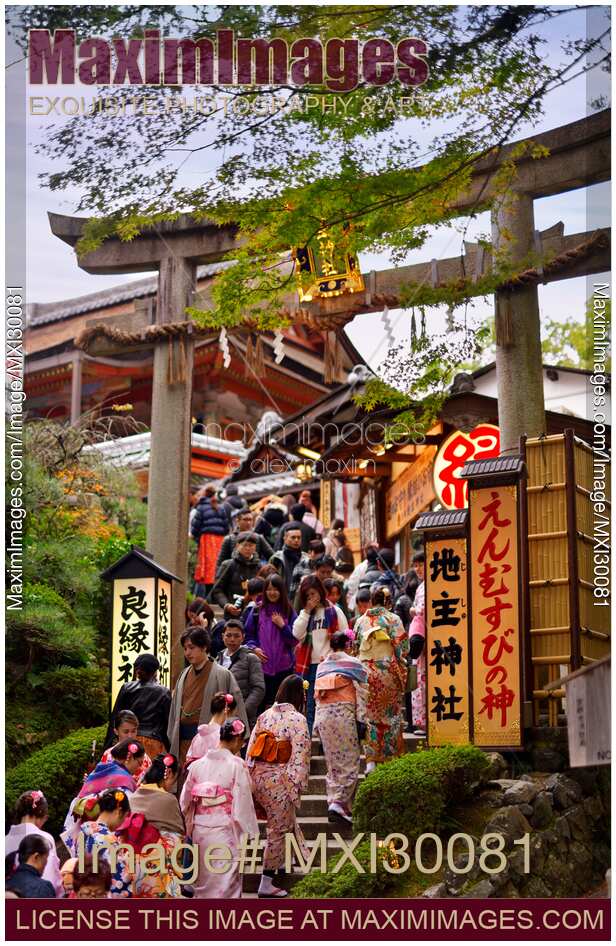 People entering Torii gate to Jishu-Jinja shrine at Kiyomizu-dera Buddhist temple in Kyoto Japan