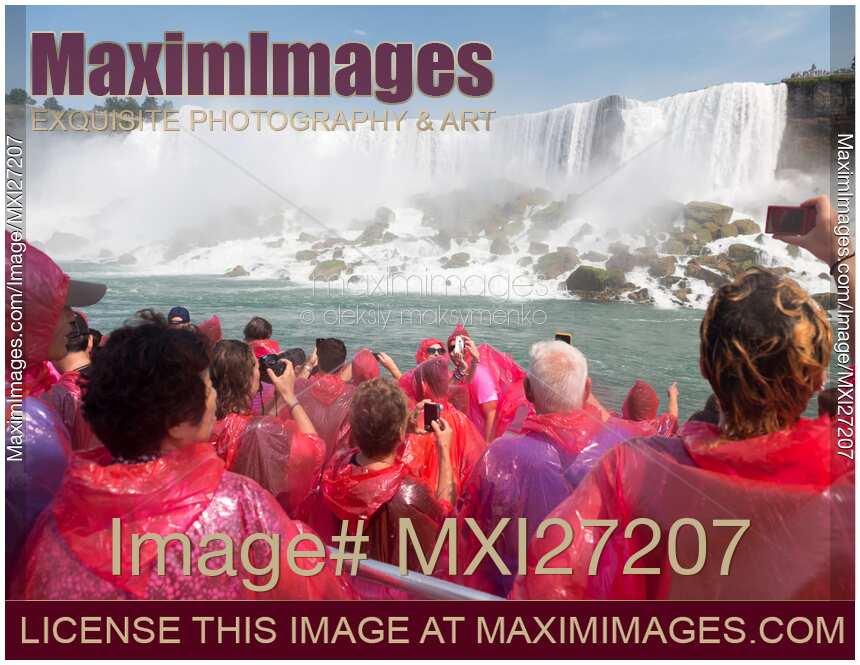 People in pink raincoats on boat ride at Niagara Falls