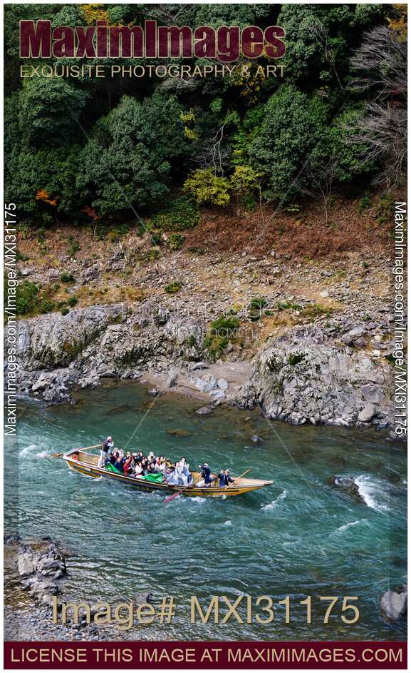 People on Hozugawa river sightseeing cruise boat ride Japan