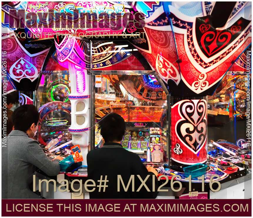 People playing DreamSphere slot machine at arcade in Odaiba Tokyo