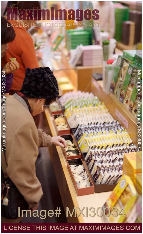 People sampling Japanese sweets Yatsuhashi at souvenir confectionery store in Kyoto