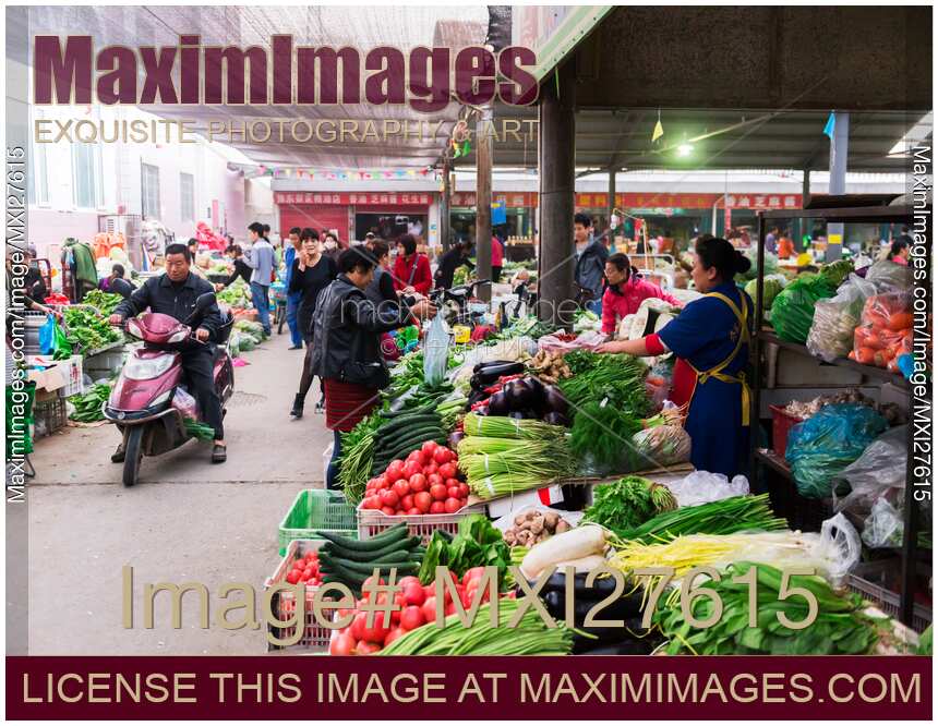 People selling vegetables at food market in China