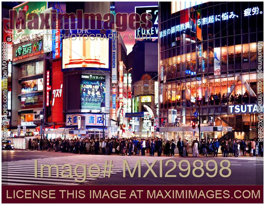 People standing at the Wolrds busiest Shibuya intersection waiting for the green light to start crossing Tokyo Japan