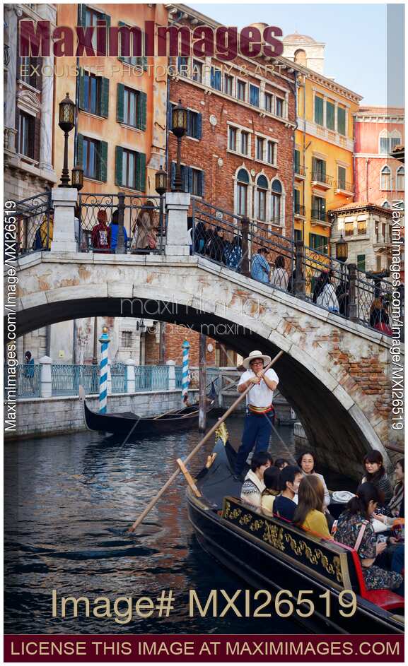 People taking a ride in Venetian gondola at Tokyo Disneysea
