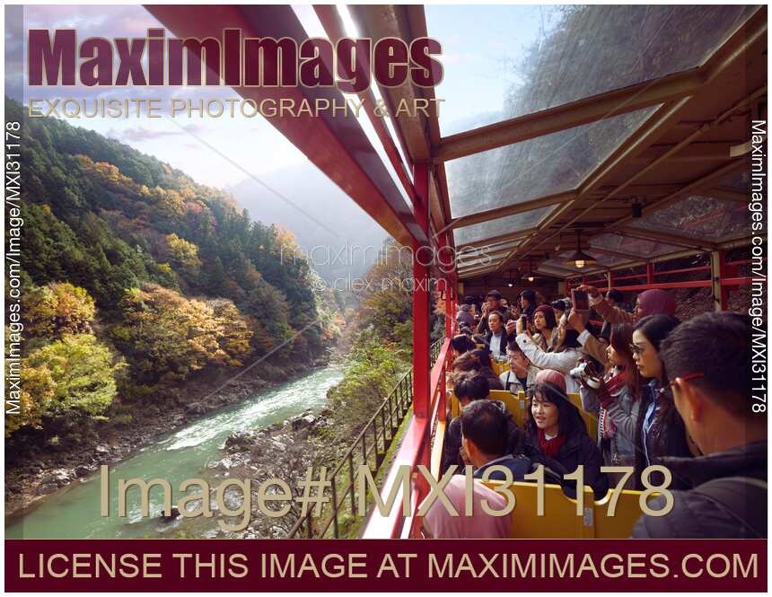 People taking pictures of Hozukyo Ravine scenery on Sagano Romantic train ride