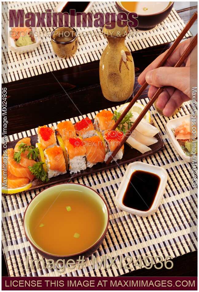 Person eating sushi at Japanese restaurant