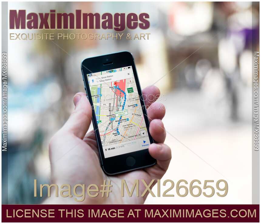 Person holding iPhone with GPS maps in hand
