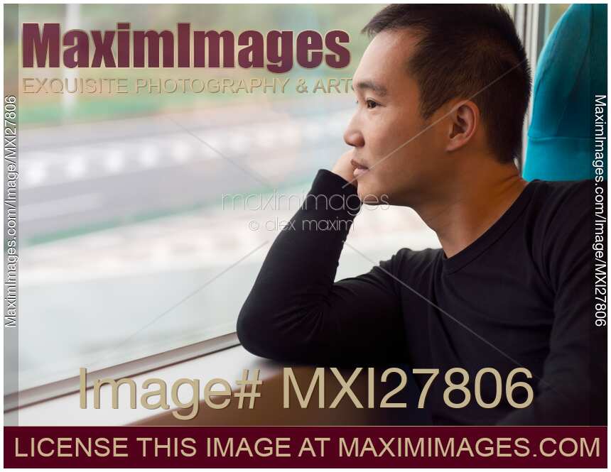 Person looking out of a window of a high-speed train