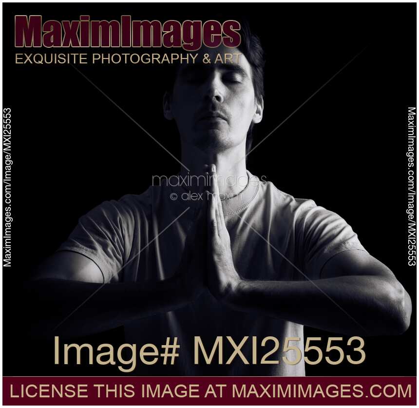 Person meditating with hands clasped