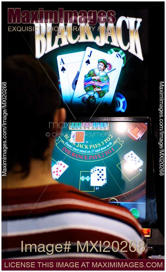 Person Playing Black Jack Slot Machine in a Casino