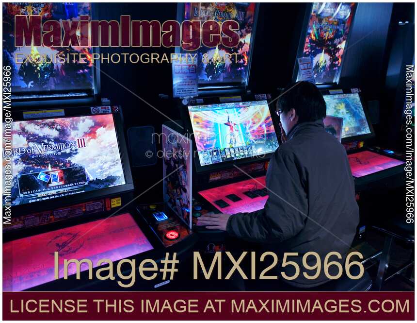 Person playing Lord of Vermilion arcade slot machines