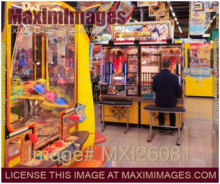 Person playing Monster Hunter arcade slot machine