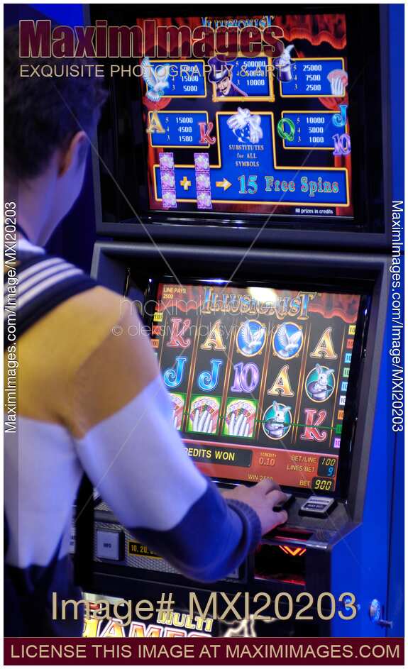 Person Playing Slot Machine in Casino