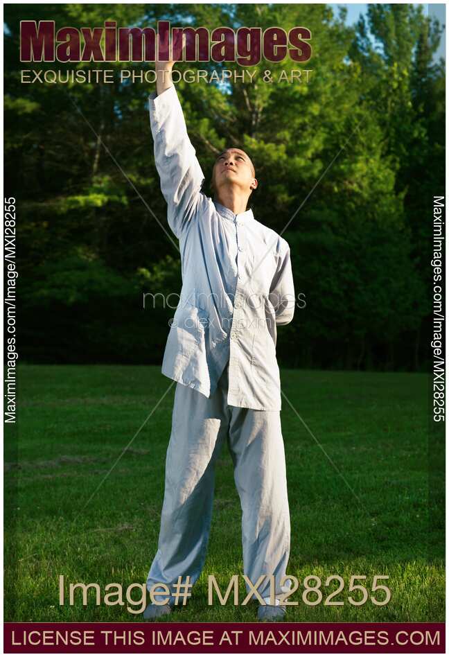 Person practicing sunrise Qi Gong in the nature