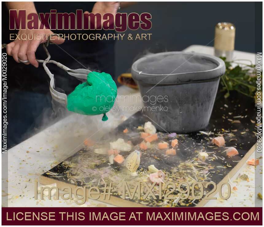 Person Taking a Shrunk Air Balloon out of Liquid Nitrogen