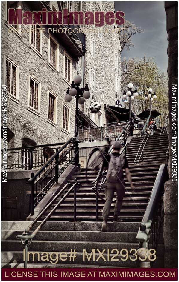 Person walking up the stairs of historic street Rue du Petit Champlain of Old Quebec City