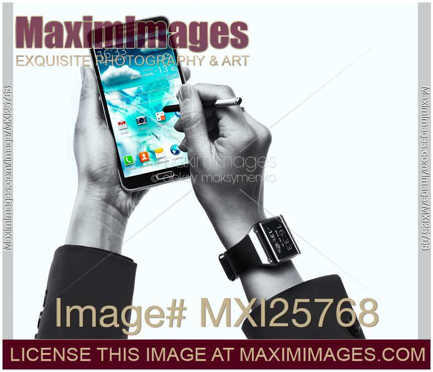 Person with Samsung Galaxy Note III smartphone and Galaxy Gear watch