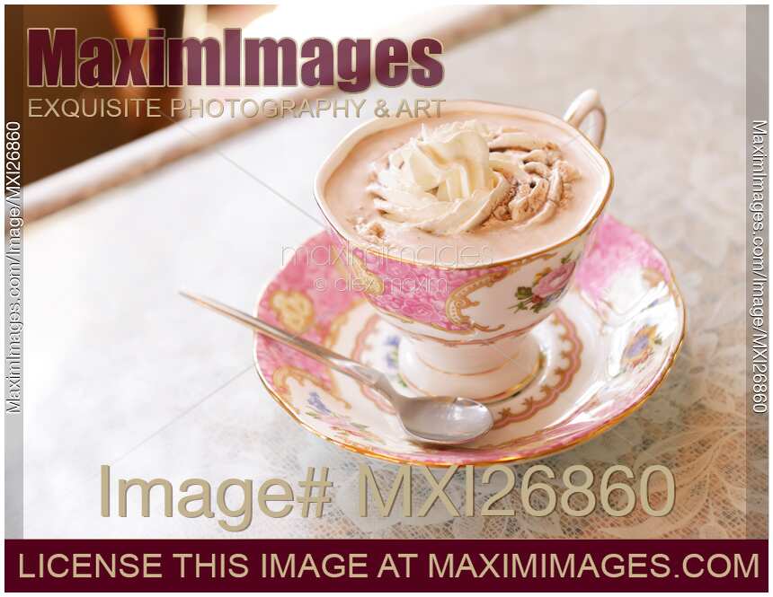 Porcelain cup of hot chocolate with cream