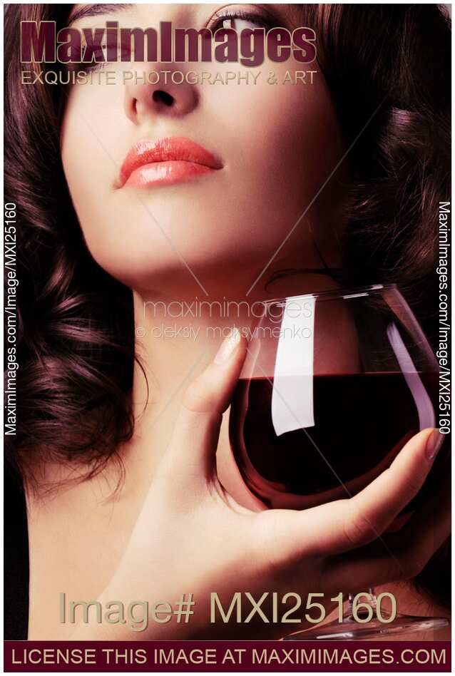 Portrait of a beautiful woman with glass of wine