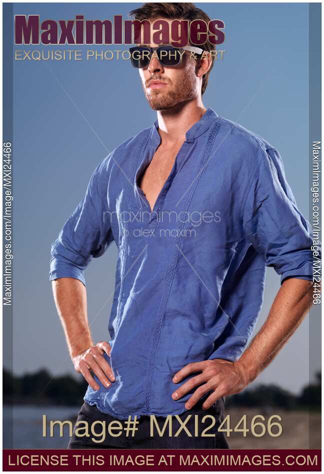 Portrait of a man in blue shirt at the beach