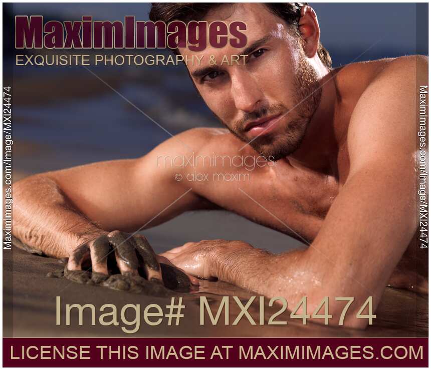 Portrait of a man lying on a sea shore