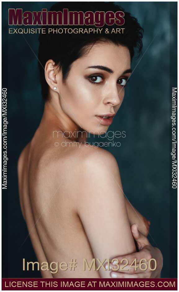 Portrait of a sexy topless woman with short dark hair and an expressive look