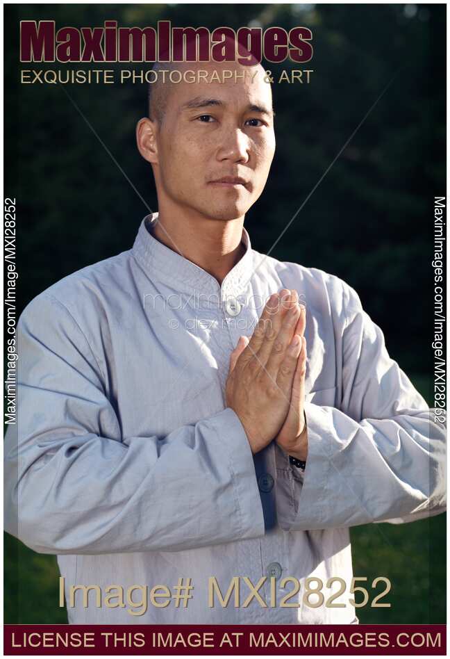 Portrait of a Shaolin warrior monk with folded hands