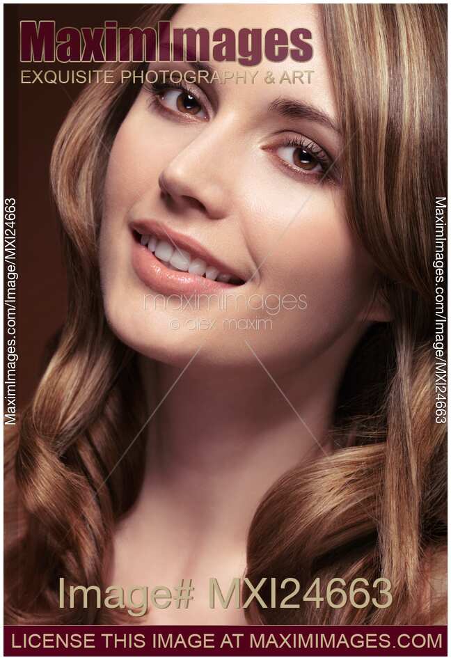 Portrait of a smiling beautiful woman with long brown hair