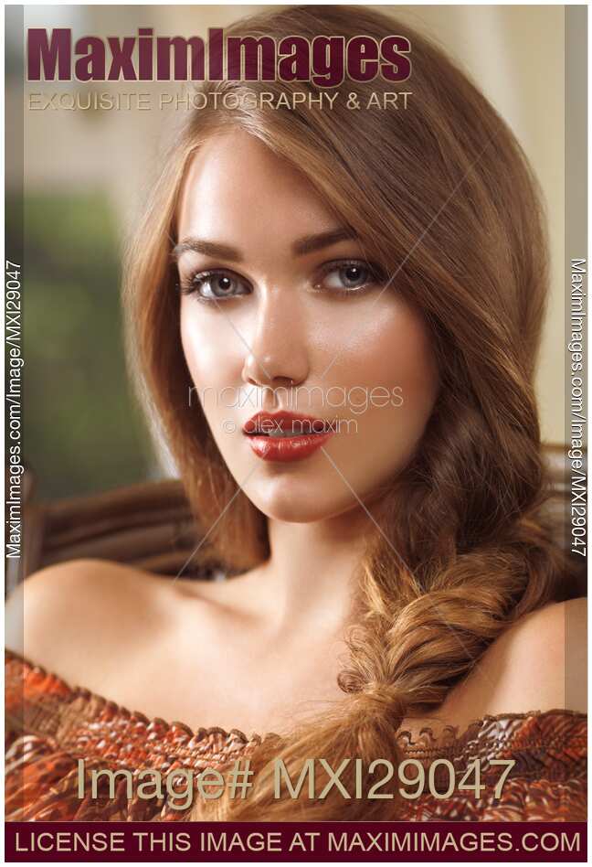 Portrait of a young woman with hair in a braid sitting in a chear