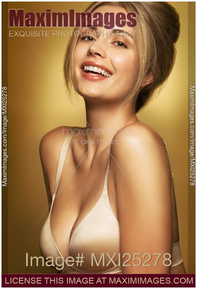 Portrait of beautiful smiling woman wearing bra in golden colors