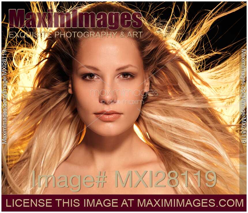 Portrait of beautiful woman face with glowing golden blond hair