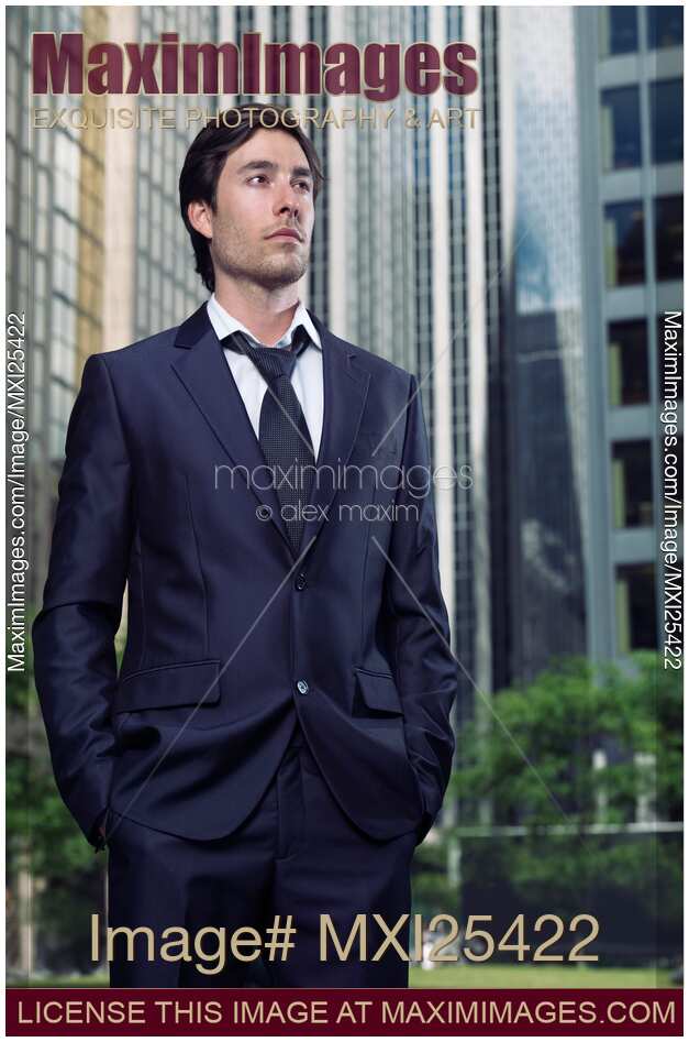 Portrait of business man with office buildings behind him
