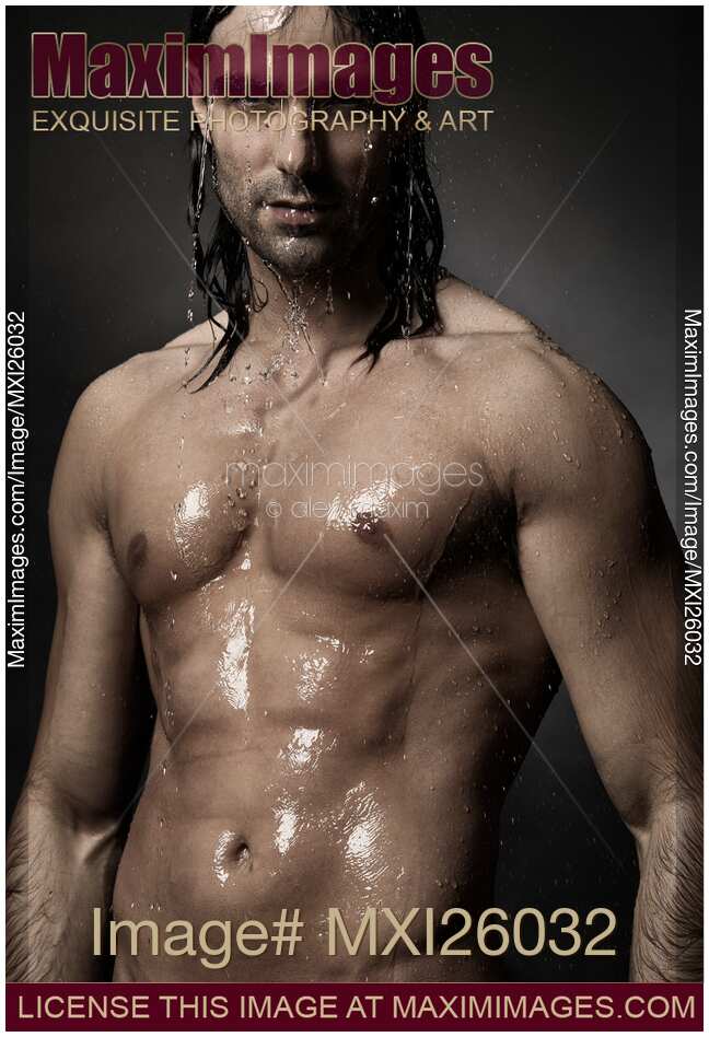Portrait of man with wet bare torso standing under shower