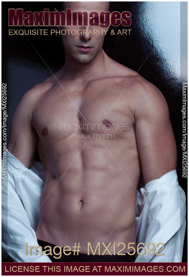 Portrait of muscular sexy man taking off his shirt