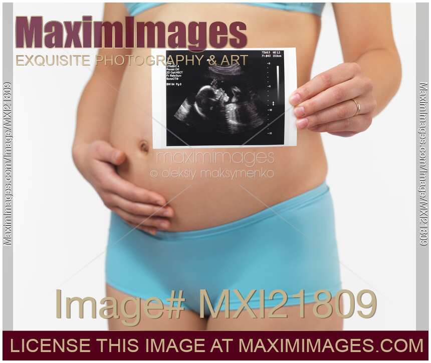 Preganant Woman Holding Ultrasound Image of Her Baby