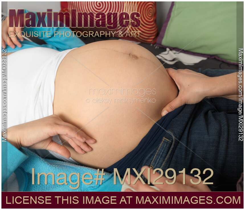 Pregnant Woman Being Inspected by a Midwife