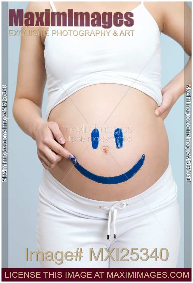 Pregnant woman belly with happy smiley