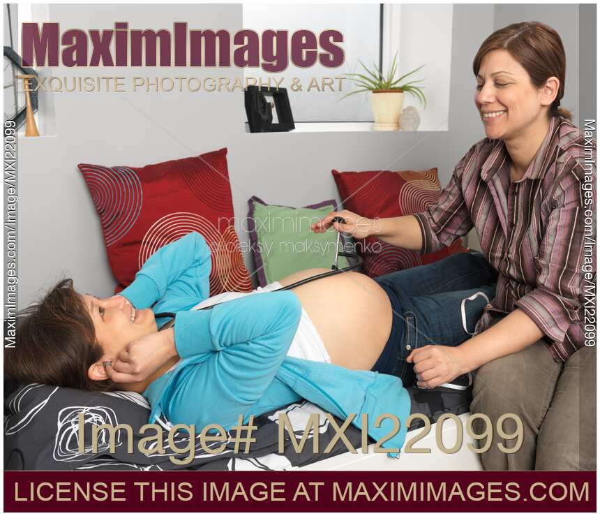 Pregnant Woman Listening to Her Baby Heartbeat