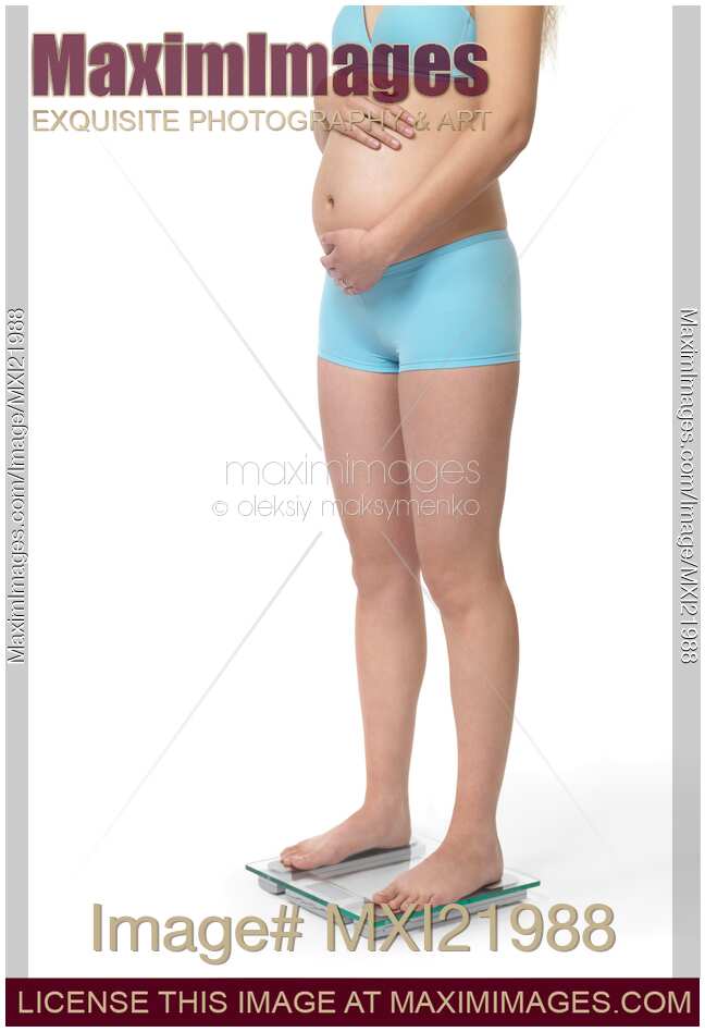 Pregnant Woman on a Weight Scale