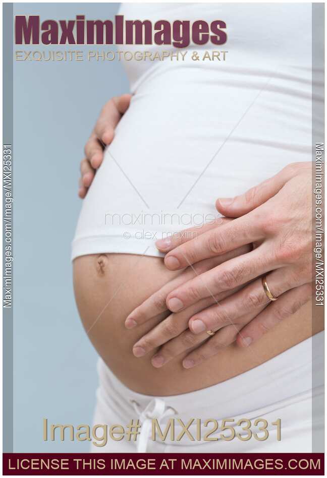 Pregnant Woman with Hands On Her Belly