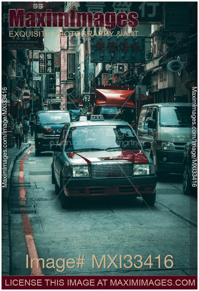 Red Cab taxi car on busy streets of Hong Kong, China