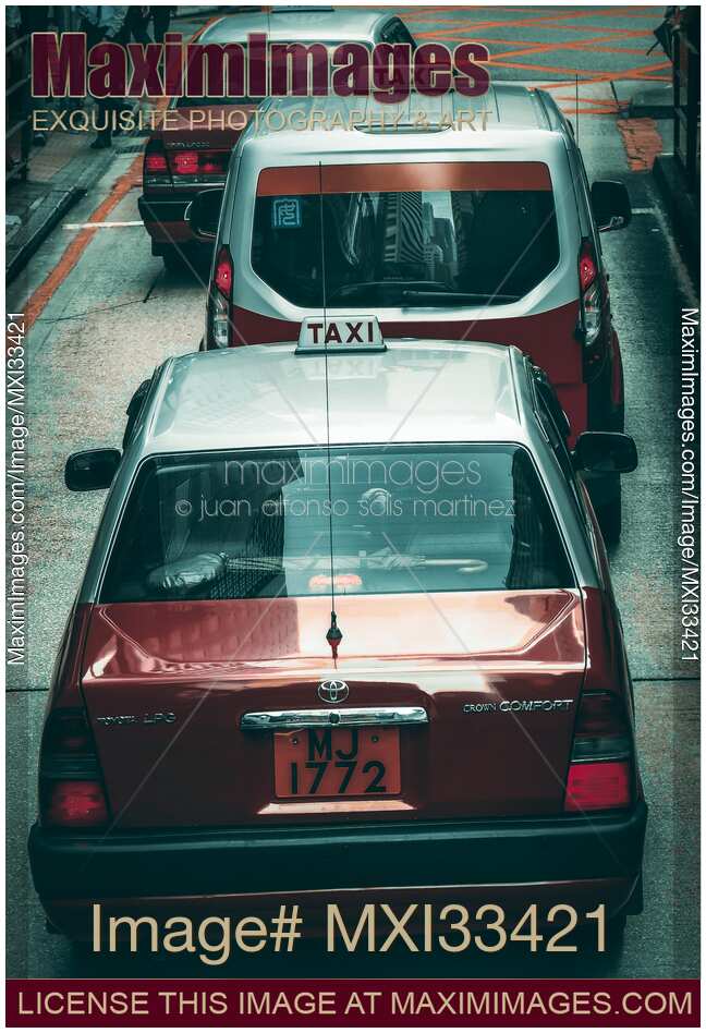 Red Cab taxi cars on streets of Hong Kong, China