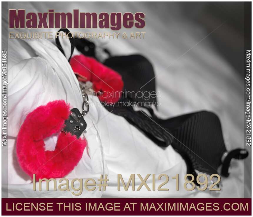Red Handcuffs and lingerie on bed