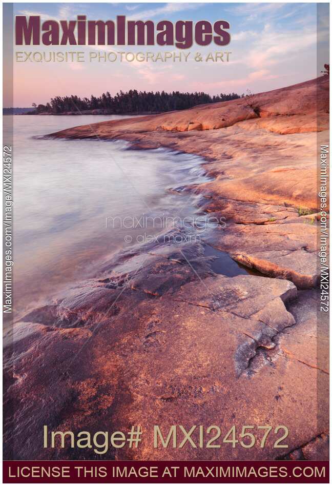 Red rocks on a lake shore at dawn