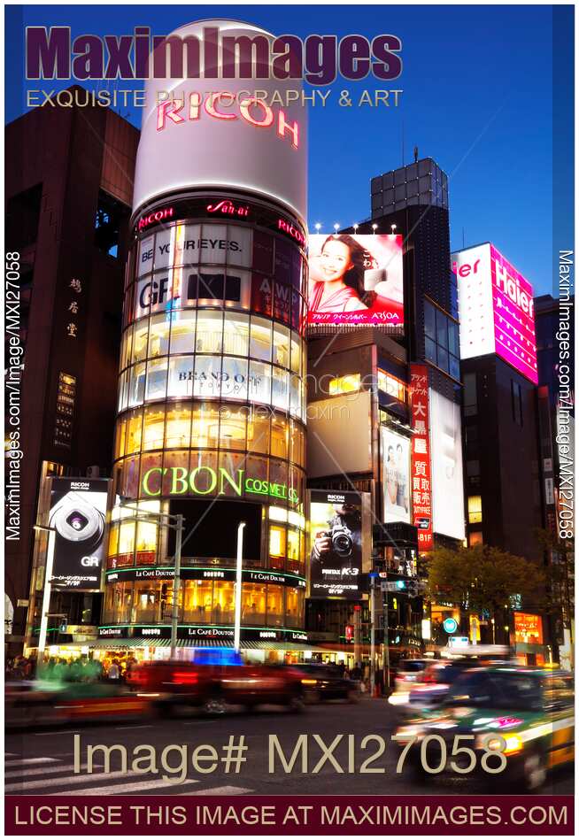 Ricoh building and colorful signs at night in Tokyo