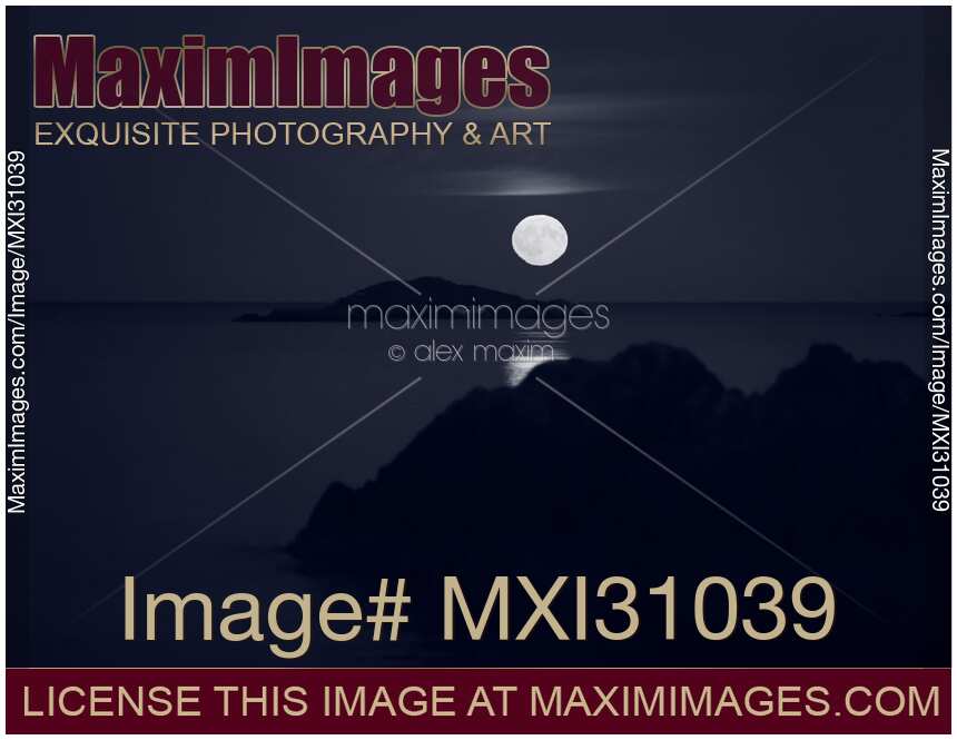 Rising big Full Harvest Moon above Pacific ocean Monochrome