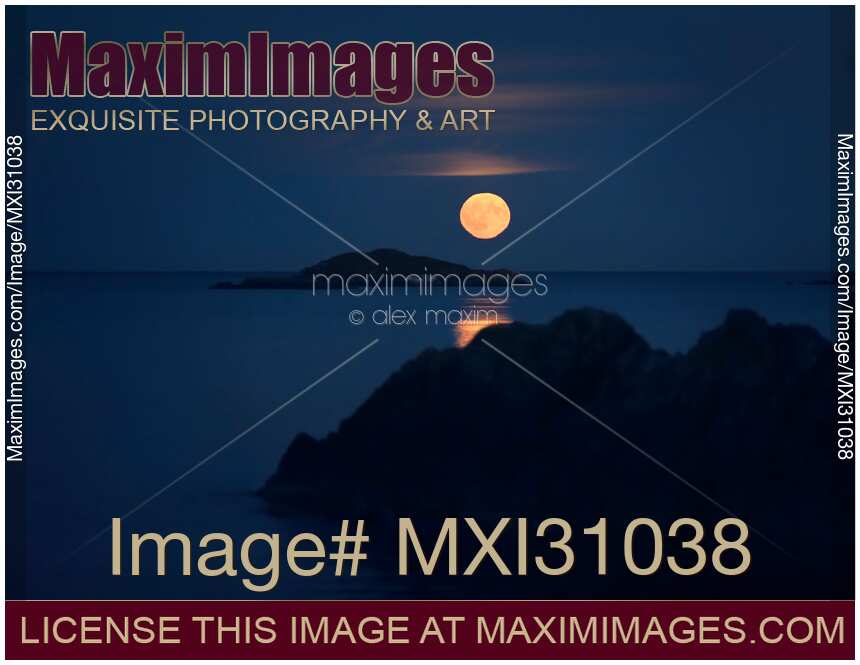 Rising big red Blood Moon Full Harvest Moon above Pacific ocean