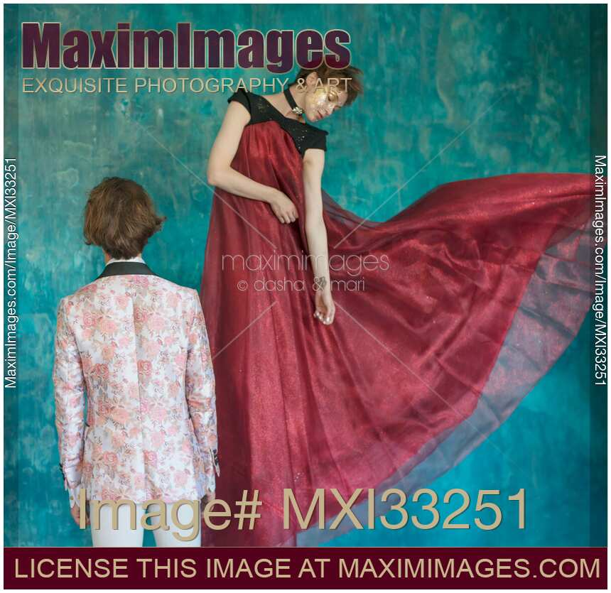 Romantic magician couple, a man and a woman is levitating in beautiful red dress